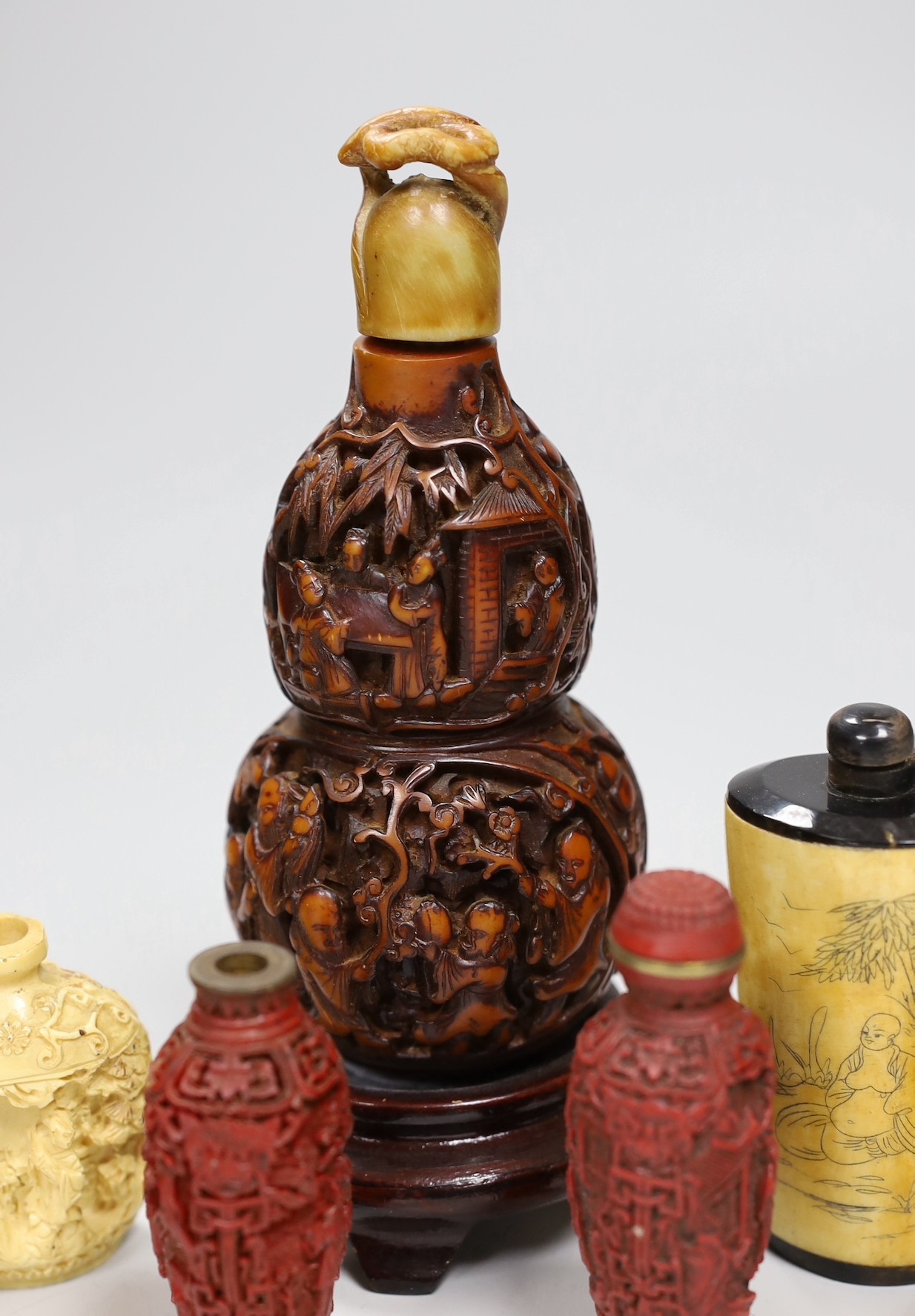 A large Chinese 20th century carved snuff bottle and smaller snuff bottles, all resin